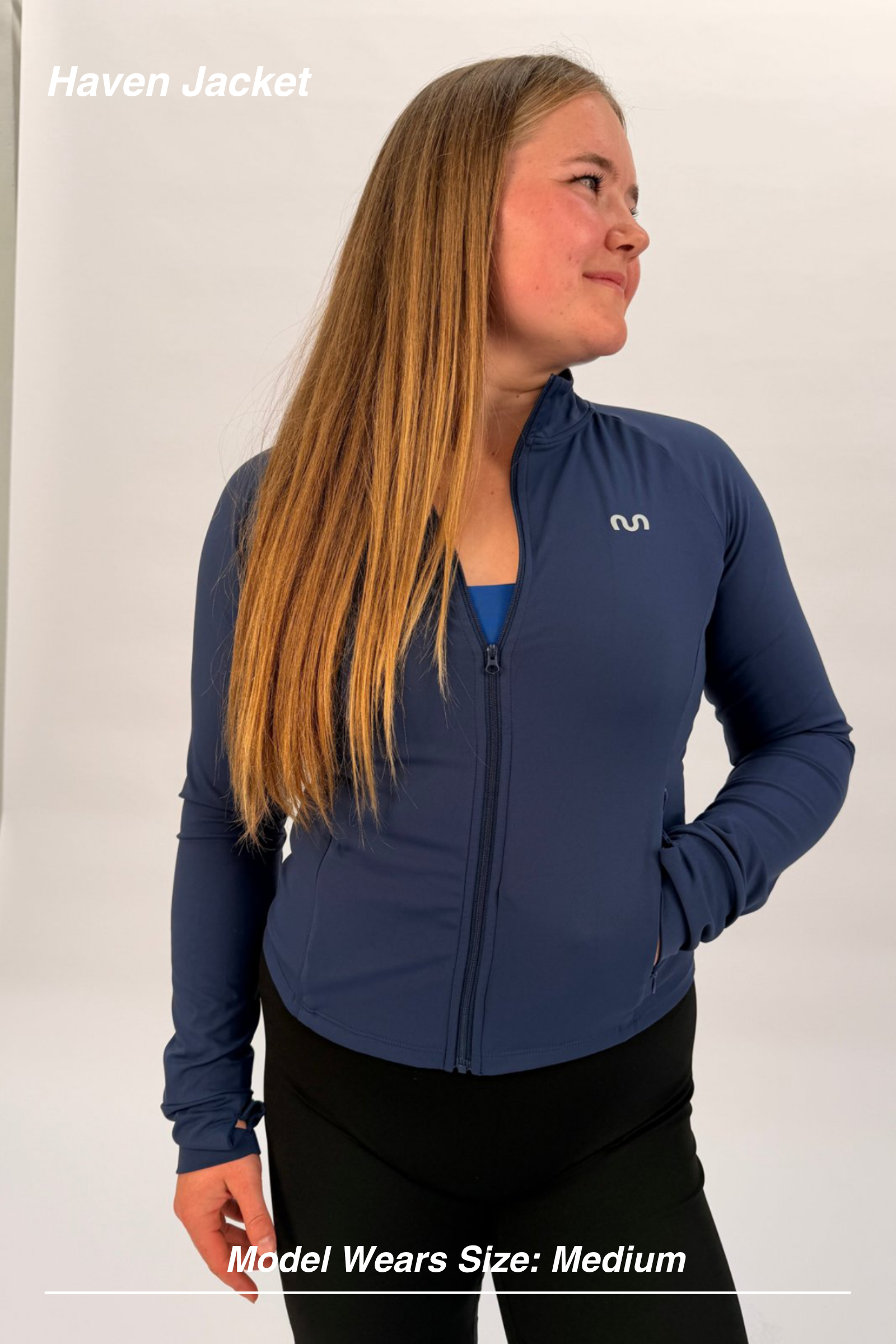 Mint Activewear Haven Jacket in navy, front three-quarter view with full-length zip and silver M logo.