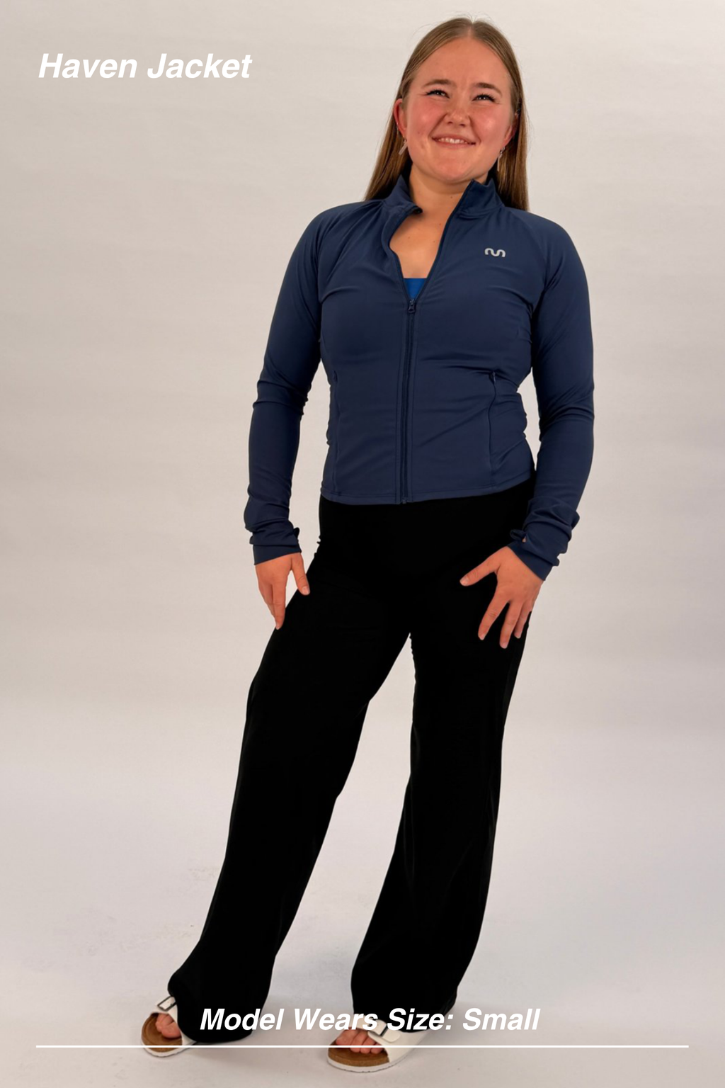 Mint Activewear Haven Jacket in navy, full-length front view styled over black pants with thumbholes.