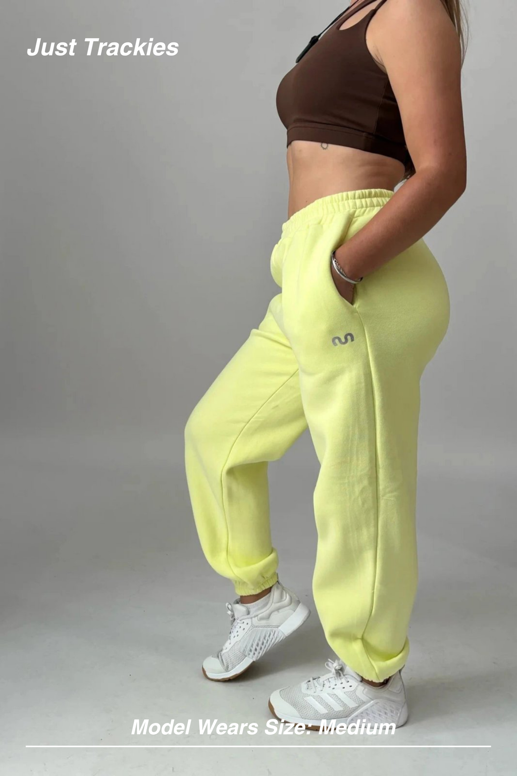 Mint Activewear Just Trackies in yellow, side view showing the relaxed oversized fit and cuffed ankles.