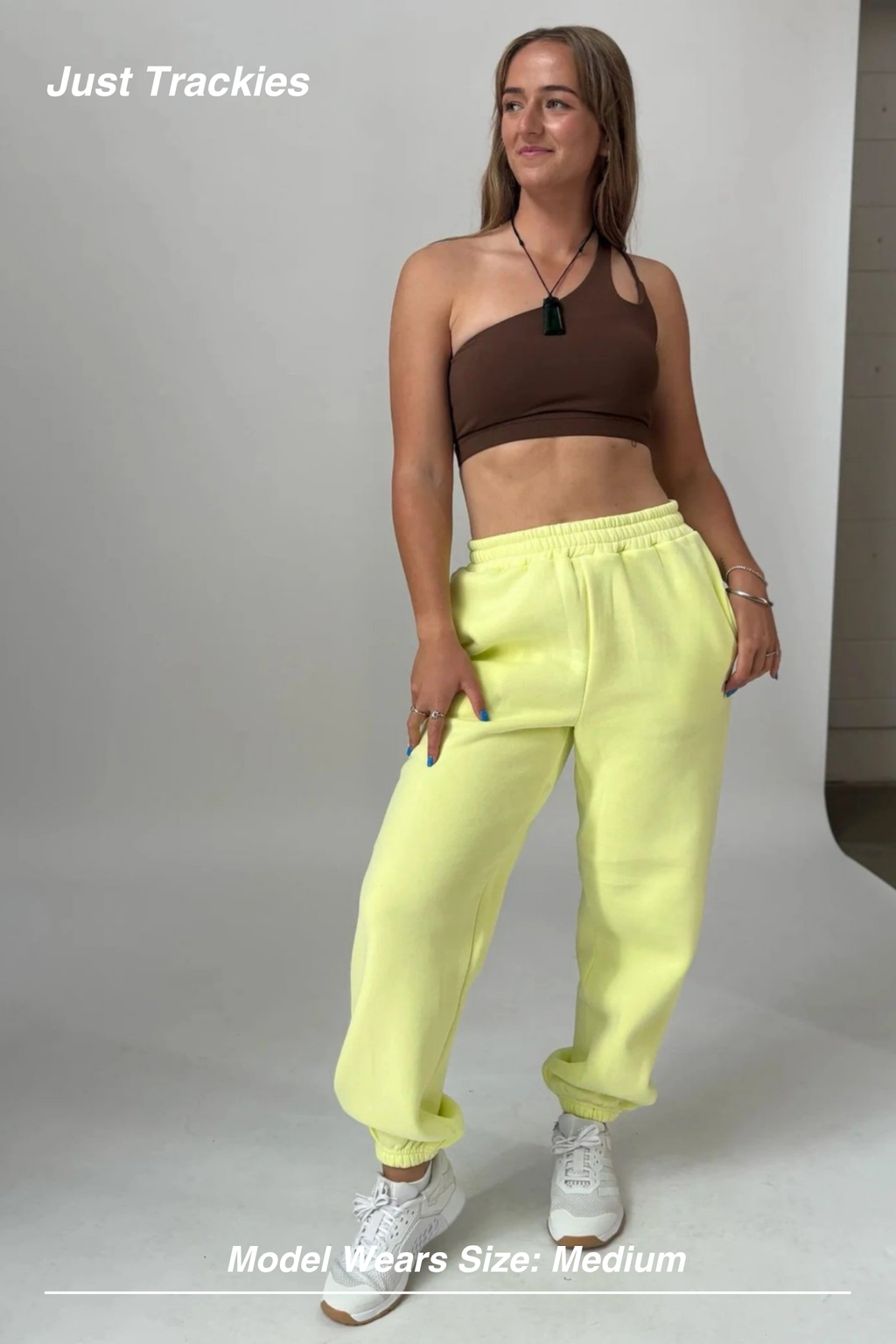 Mint Activewear Just Trackies in yellow, full-length front view styled with a cropped top and trainers.