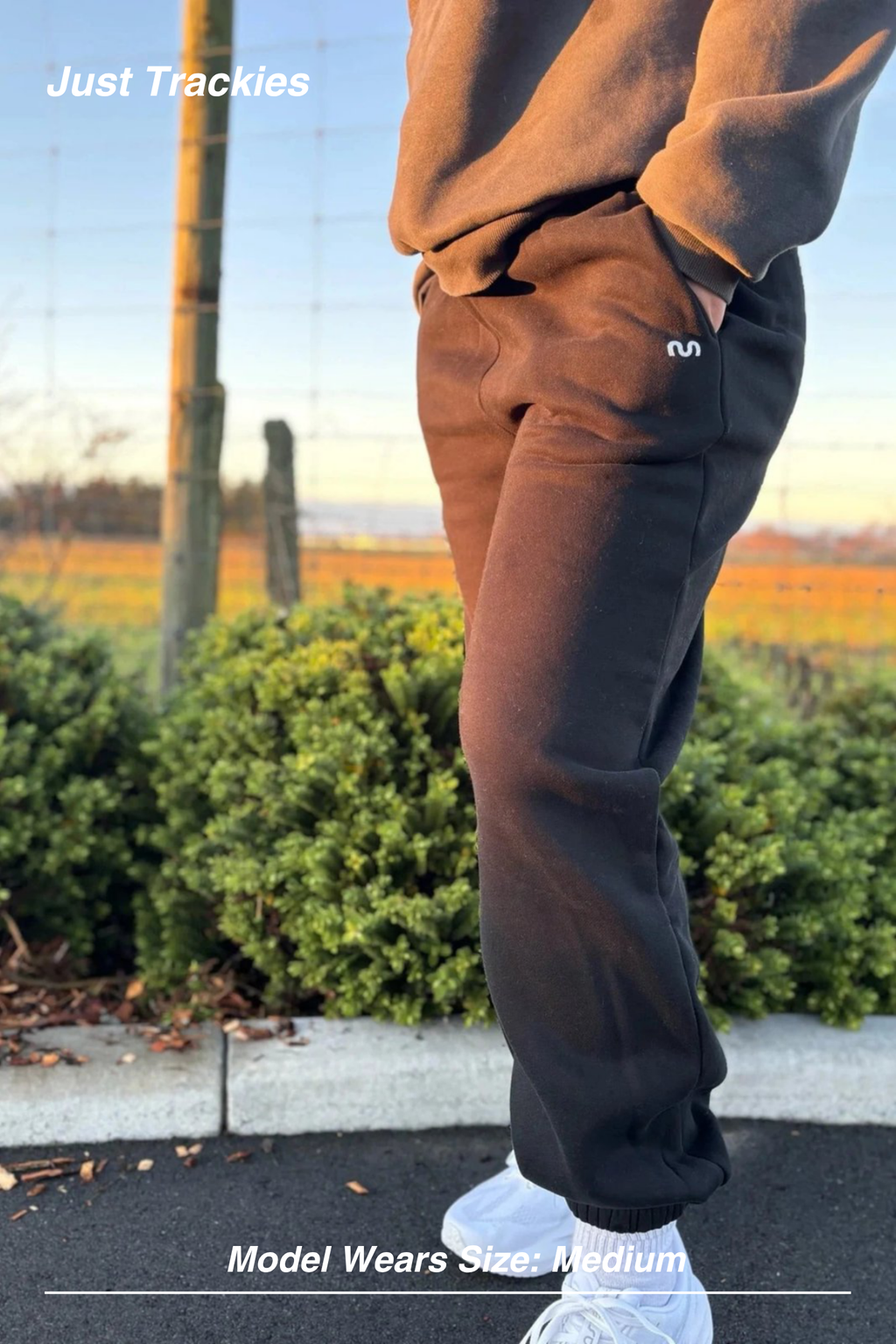 Mint Activewear Just Trackies in chocolate brown, side view outdoors showing the tapered cuffed ankle.