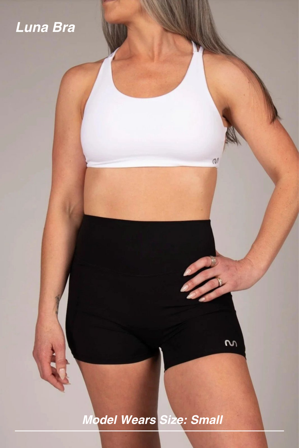 Mint Activewear Luna Bra in white, front view showing the smooth minimalist front and racerback shape.
