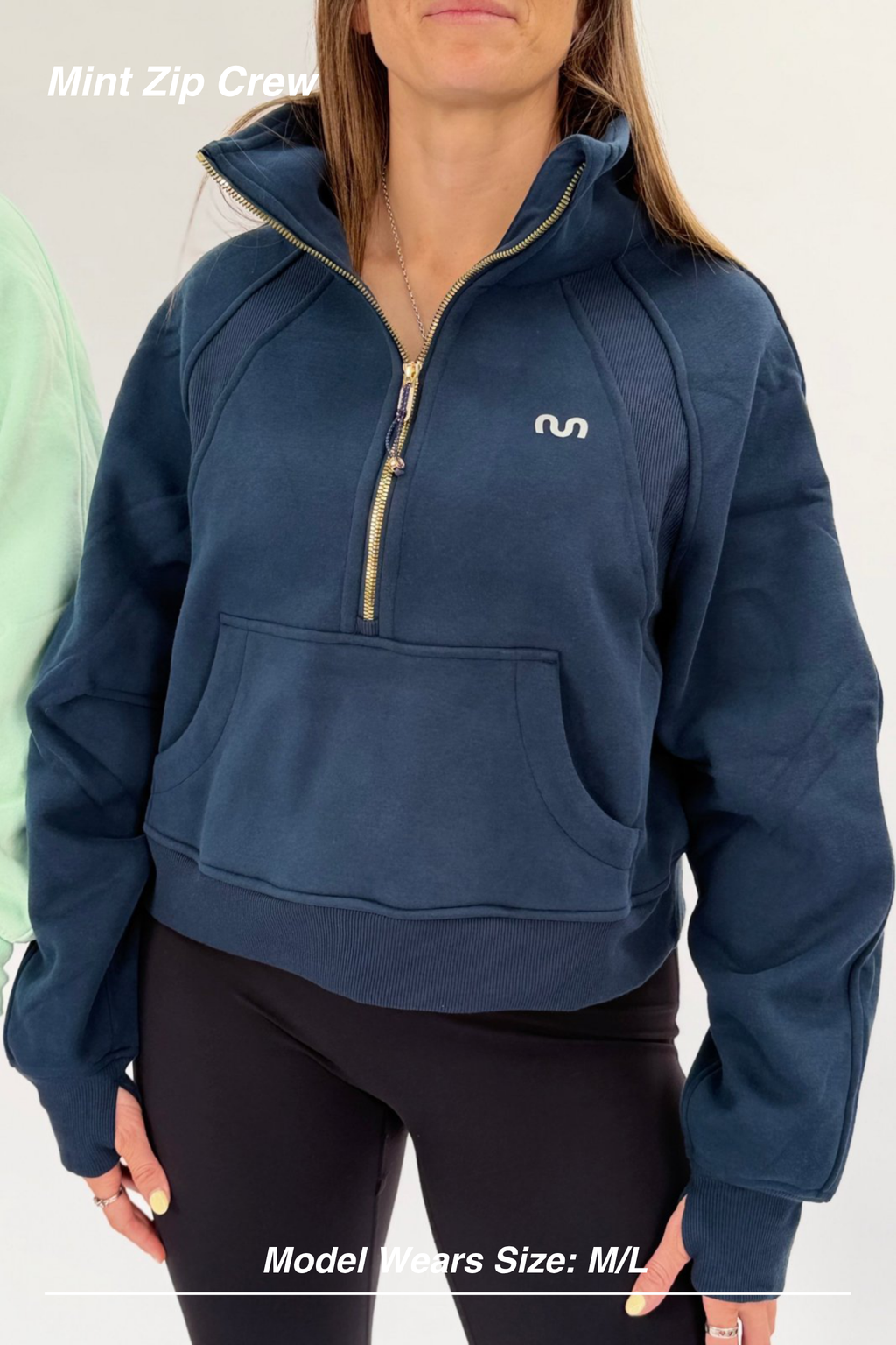 Mint Activewear Mint Zip Crew in navy, close-up front detail of the gold half-zip and front kangaroo pocket.