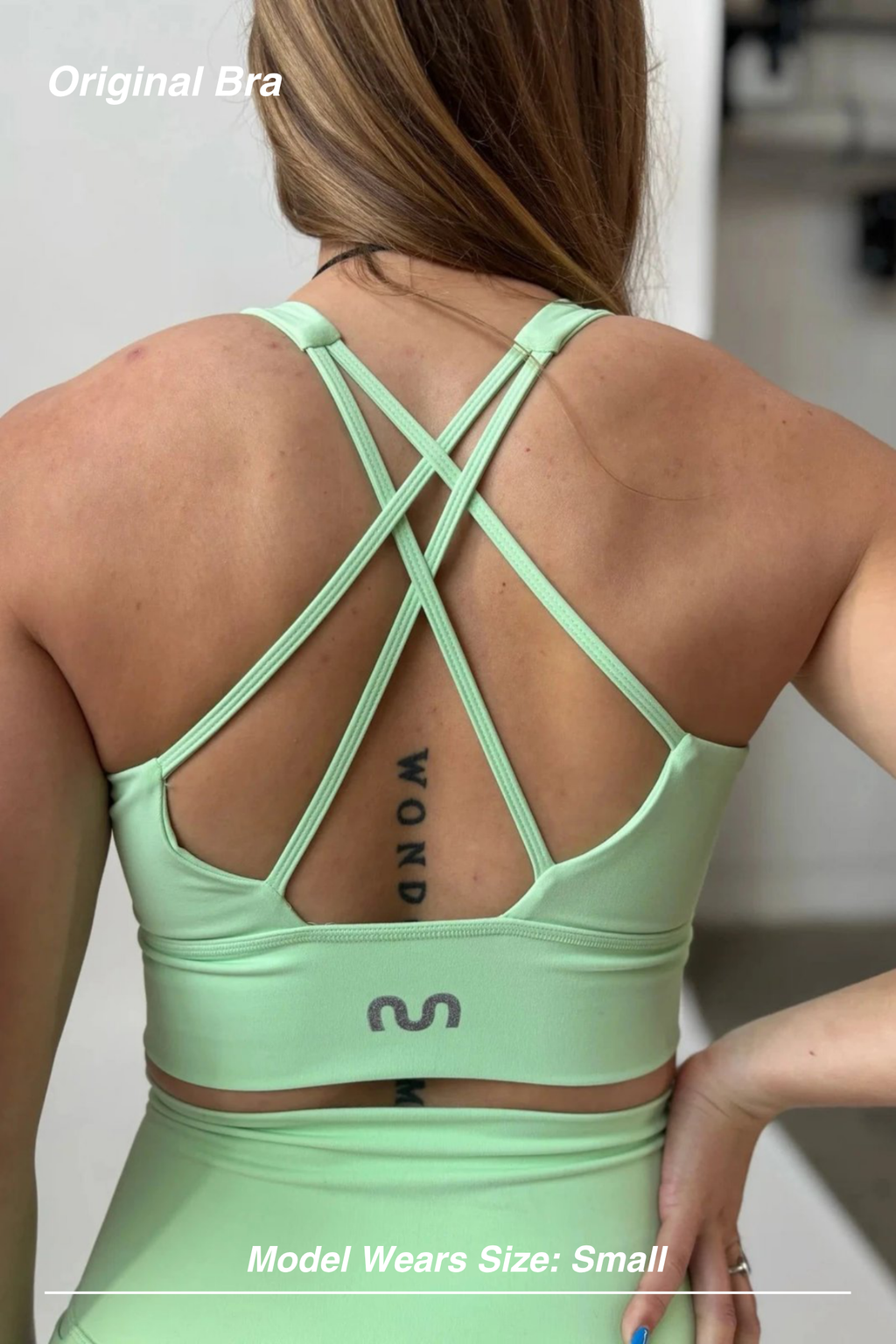 Mint Activewear Original Bra in mint green, back view showing the strappy crossed-back design and supportive band.