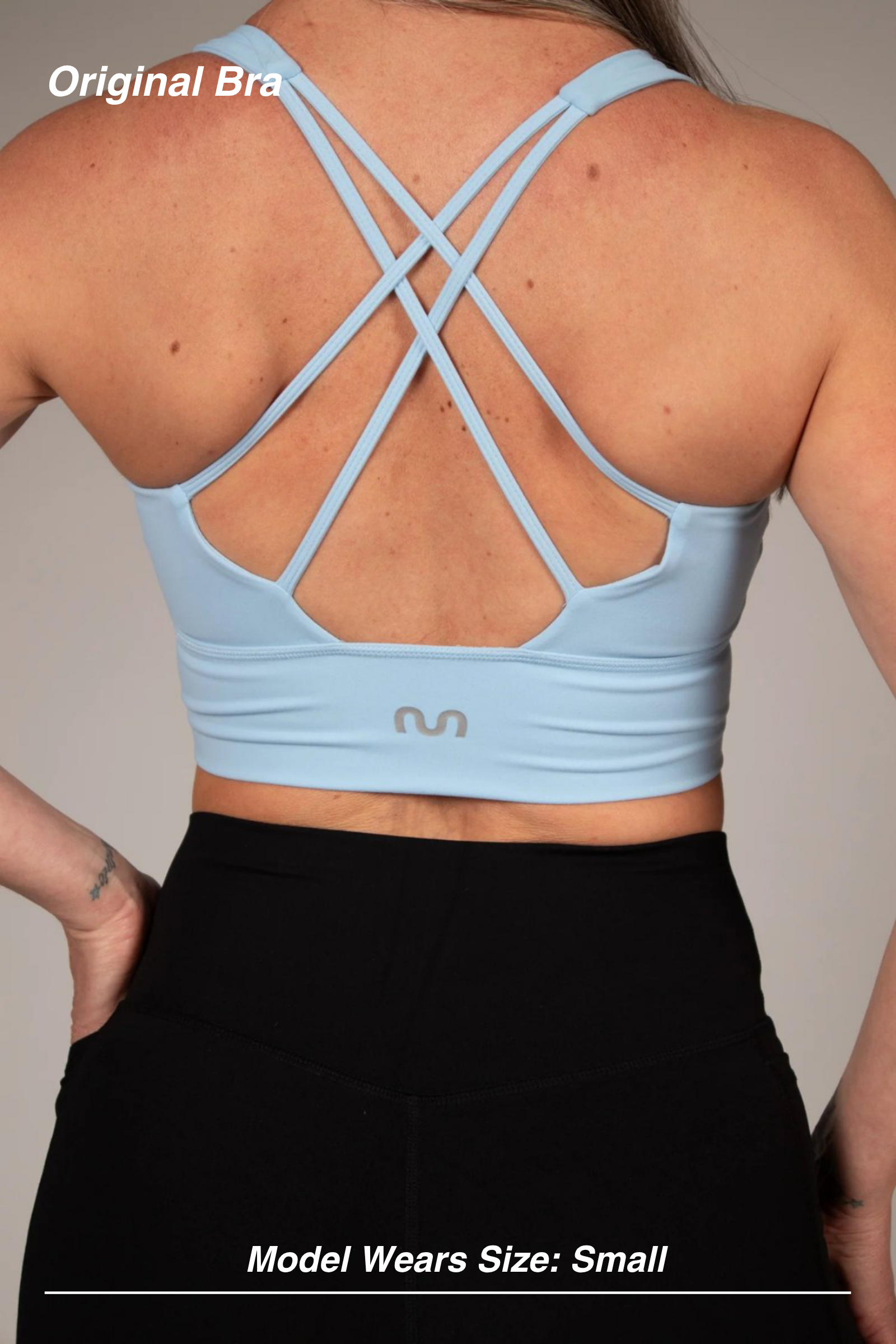 Mint Activewear Original Bra in baby blue, back view showing the strappy crossed-back design and branded band.