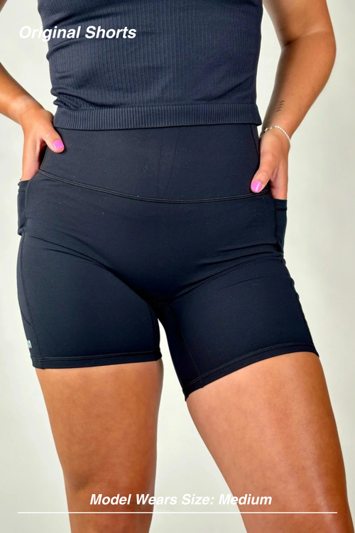 Mint Activewear Original Shorts in black, front view close-up showing the high waistband and side pocket.