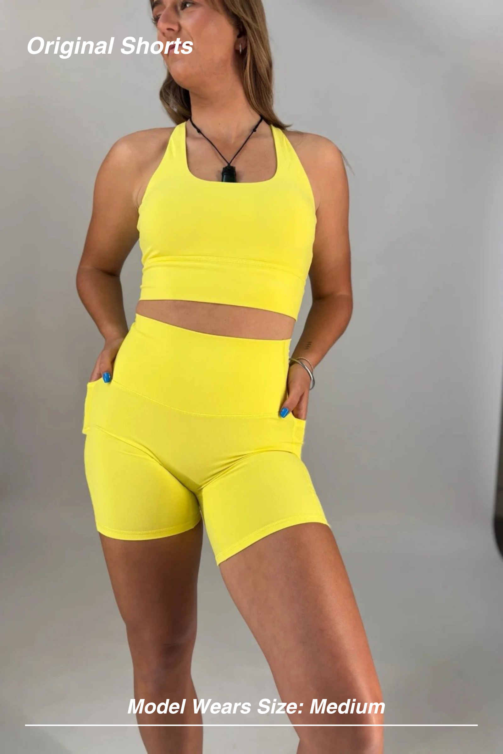 Mint Activewear Original Shorts in yellow, front view with a matching crop top and side pockets.