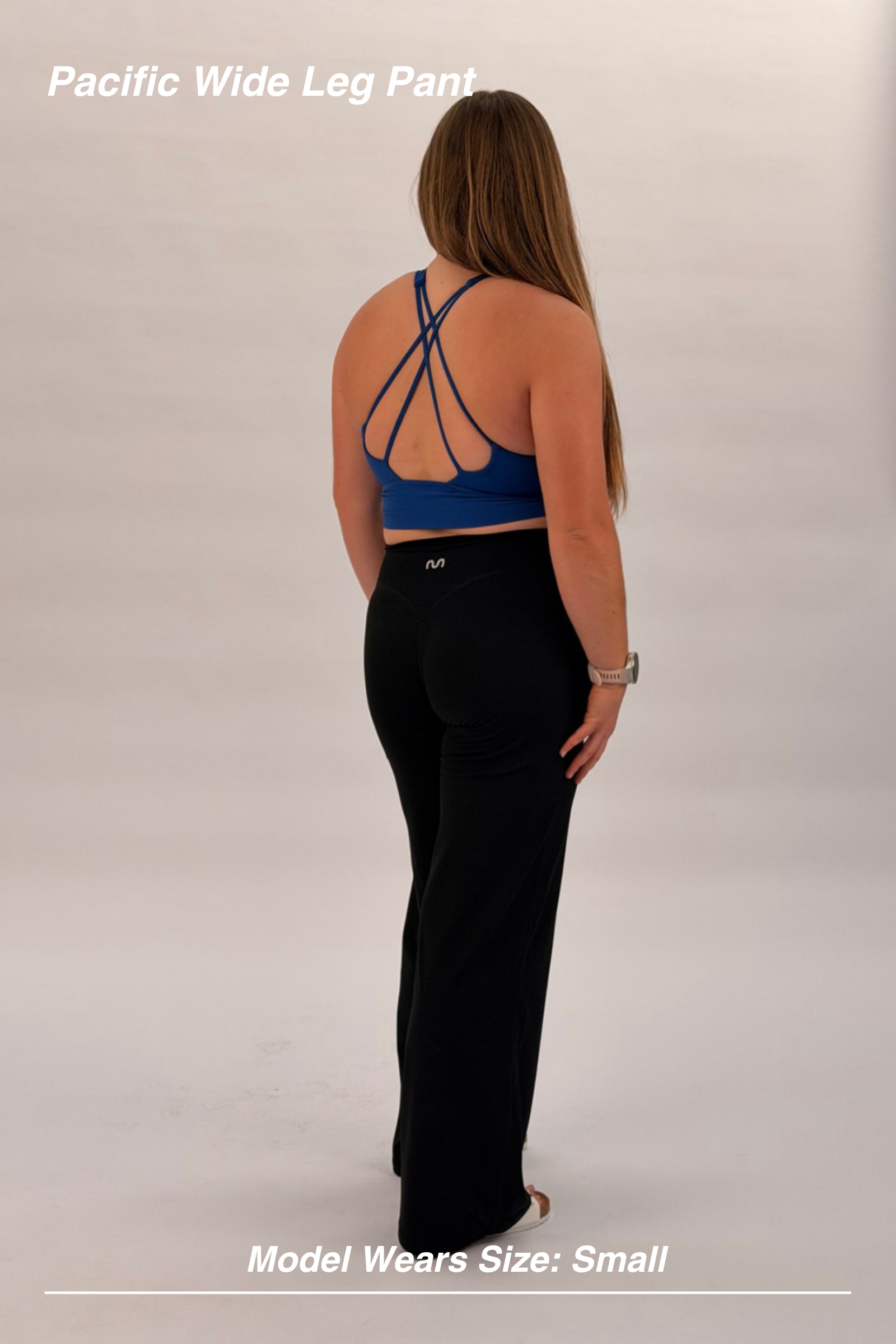 Mint Activewear Pacific Wide Leg Pant in black, back view showing the high-waisted fit and relaxed wide leg.
