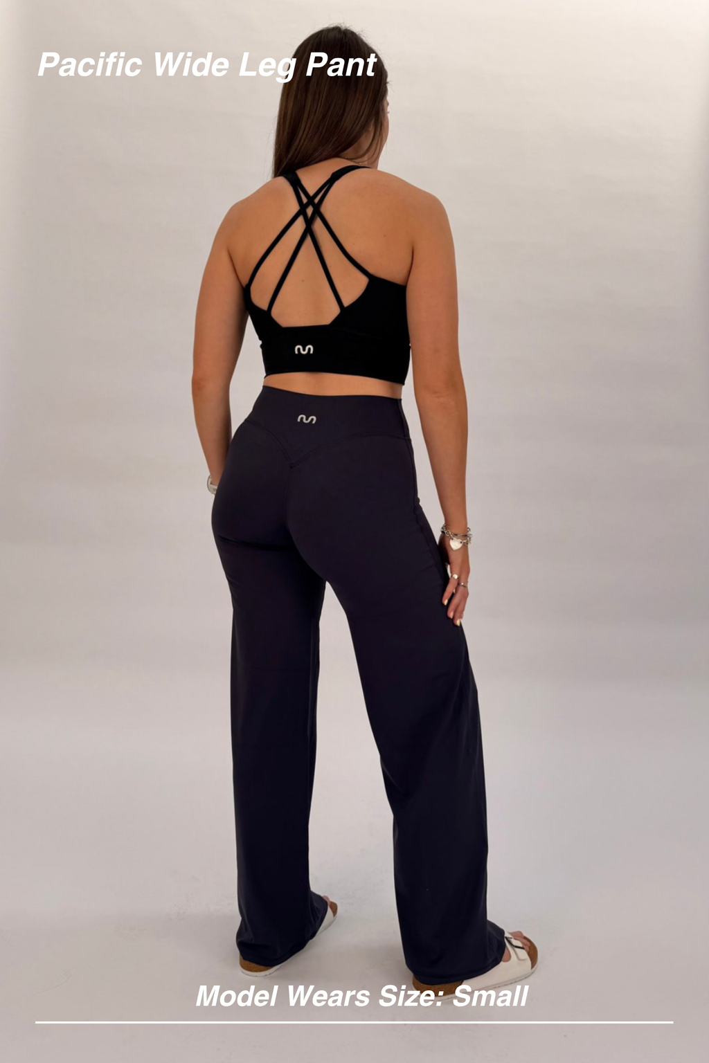 Mint Activewear Pacific Wide Leg Pant in navy, back view highlighting the supportive high waistband and flowing wide leg.