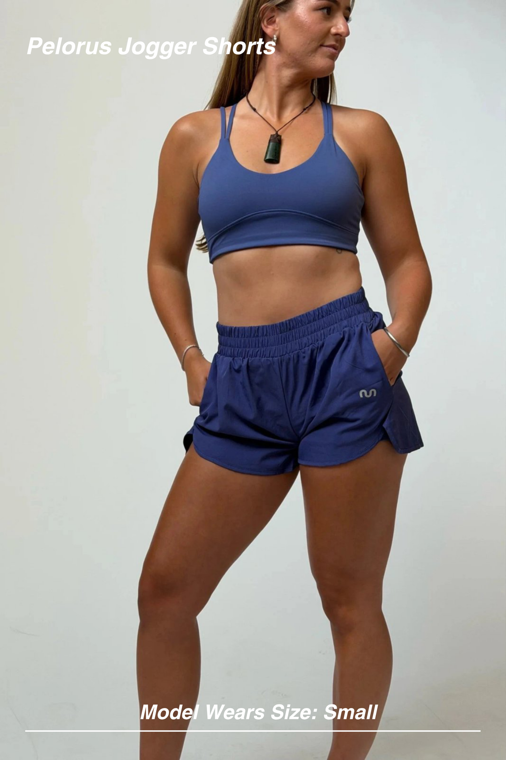 Mint Activewear Pelorus Jogger Shorts in ocean blue, front three-quarter view styled with a matching crop top.