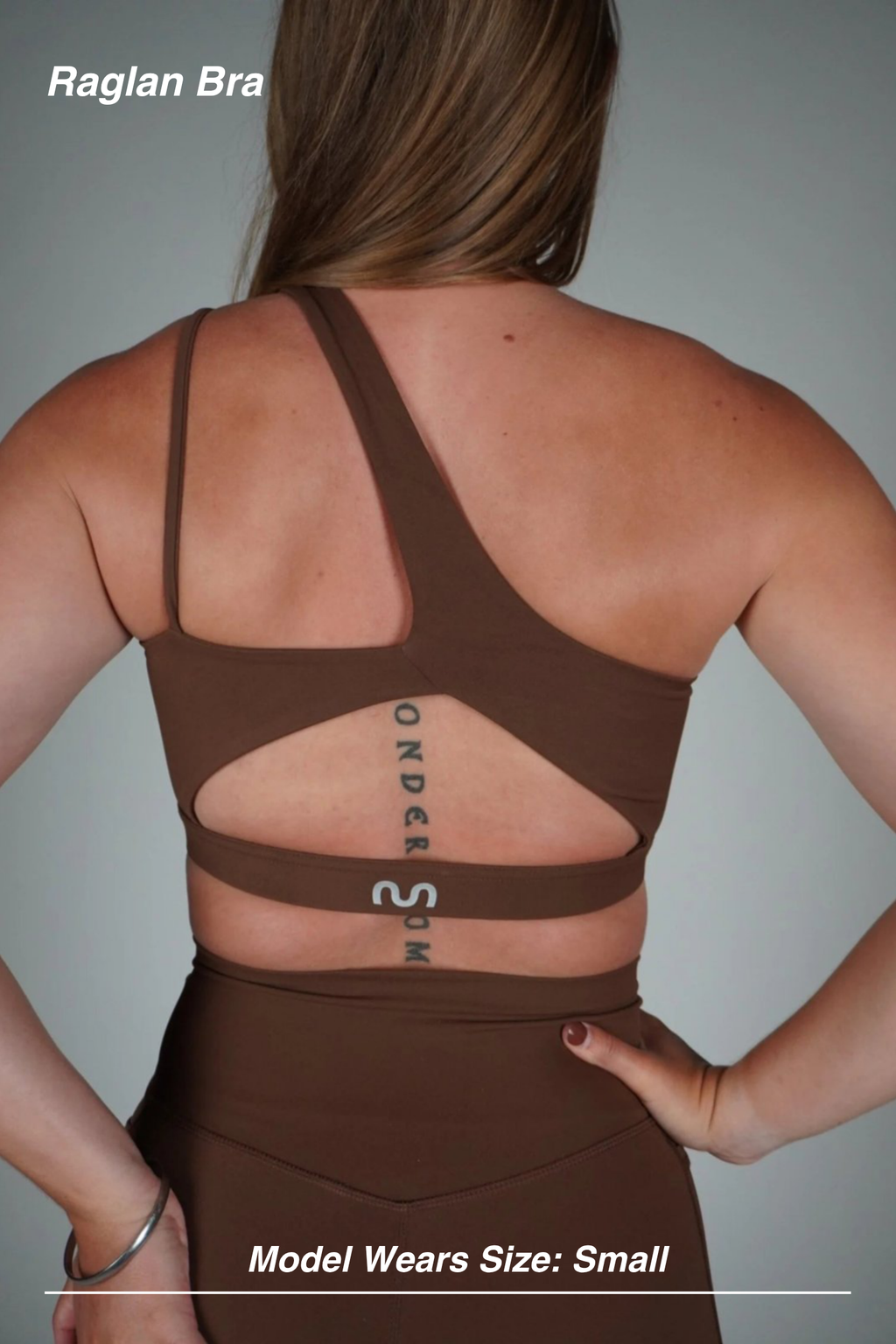 Mint Activewear Raglan Bra in Chocolate, angled back view showing the asymmetric strap and strappy back.