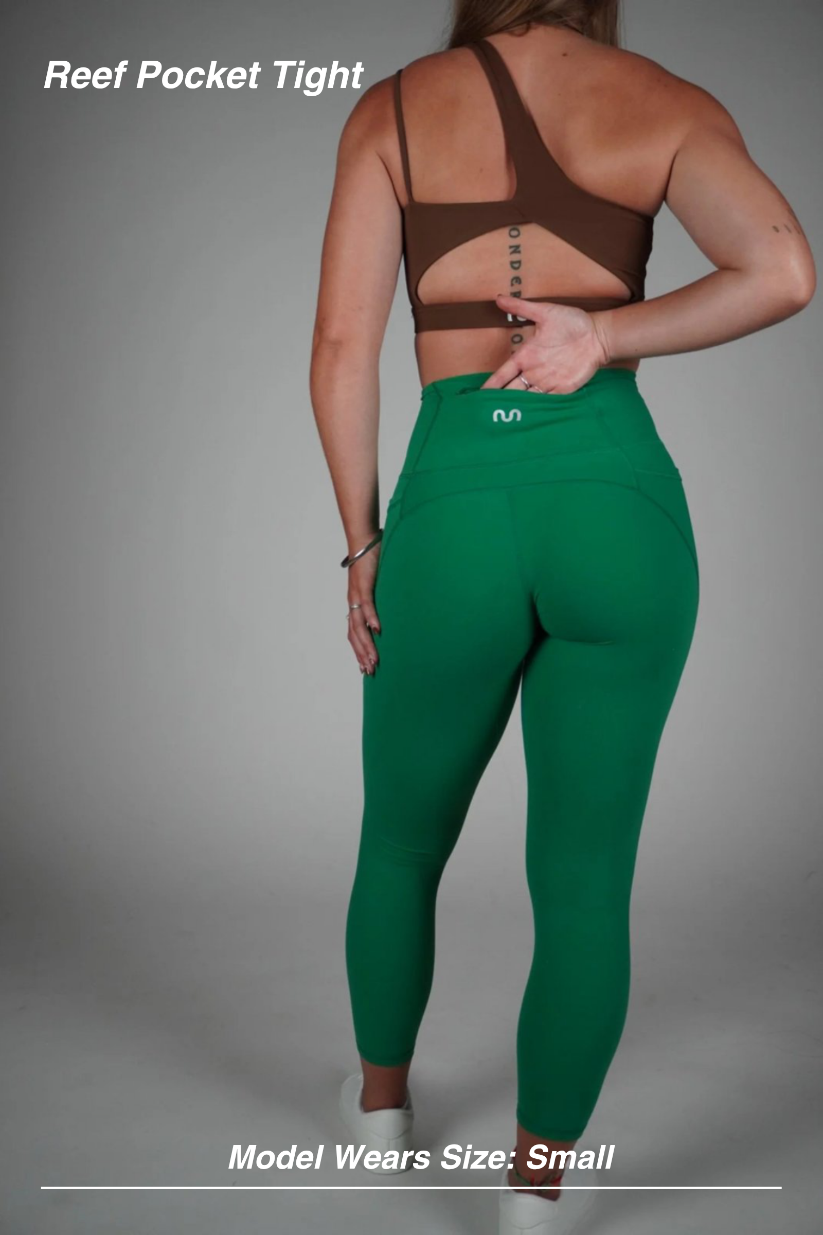 Mint Activewear Reef Pocket Tight in green, back view of the second-skin fit with hand resting at the high waistband.